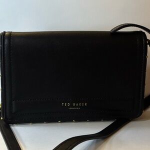 Ted Baker black crossbody bag with gold stud details and chain strap.
